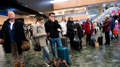 Passengers wait at Euston station, London, following train delays. PA