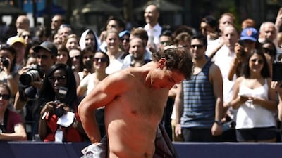 Rafael Nadal removes his jacket during an outdoor tennis exhibition in New York City on Tuesday. Justin Lane / EPA