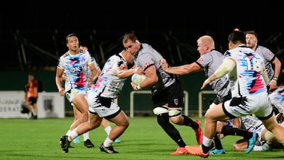 Jaen Botes breaks a tackle as UAE attack against South Korea.