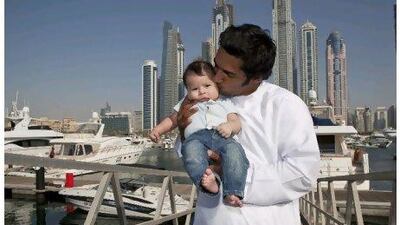 Adil Khalid, the only Emirati crew member of the Abu Dhabi Ocean Racing yacht Azzam, with his three-month-old son Abdul Raffa at the Dubai Marine Club.