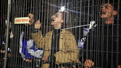 Demonstrators outside Mr Netanyahu's residence in Jerusalem. AFP