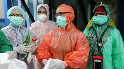 Medical workers wearing disposable raincoats as their protective suits to serve patients are pictured amid the spread of coronavirus disease outbreak at a local health centre in Aceh, Indonesia. Reuters