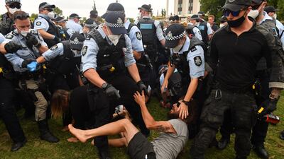 Police scuffle with an anti-vaccine protester at a makeshift camp next to the National Library, in Canberra, Australia. EPA