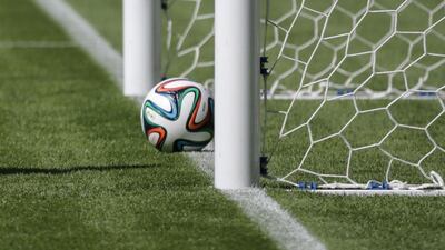This file photo taken on June 9, 2014 shows a football on the line of the goal during a presentation of the goal-line technology (GLT) to be used in the Fifa World Cup for the first time to give more accuracy to referees, at Maracana Stadium in Rio de Janeiro on June 9, 2014. Uefa will introduce goal-line technology to its competitions in time for this season's Champions League and Europa League finals, European football's governing body announced on March 4, 2016. AFP / YASUYOSHI CHIBA
