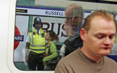 A British police officer watches commuters at Russell Square Underground Station on July 7, 2006 in London, England. On July 7, 2005 three Underground trains were hit by suicide bombers and a fourth blast on the number 30 double-decker bus at the junction of Tavistock Square and Upper Woburn place. Getty Images