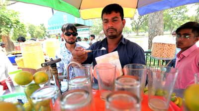 A vendor offers lemon water and lemonade to customers in New Delhi. Weather experts say reckless construction of houses, offices and roads to accommodate the city's expanding population and economy has pushed it to the brink of collapse. EPA