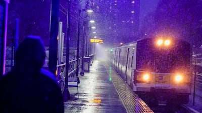 A woman waits for a Long Island Rail Road train in the Queens borough of New York. AP Photo