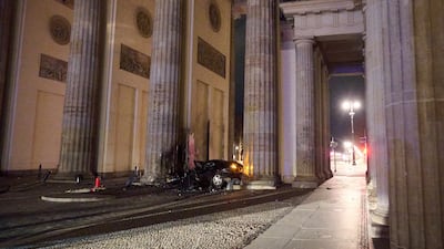 A wrecked car at Brandenburg Gate in Berlin. Firefighters found a dead man in the vehicle, police said. AP