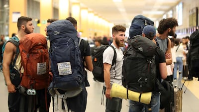 Young Israelis queue to board a flight to Tel Aviv at the Jorge Chavez International Airport in Lima, Peru, after Israel drafted more than military 300,000 reservists. EPA