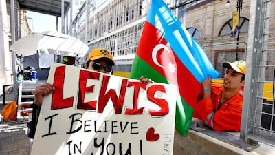 A track marshal with a Lewis Hamilton sign and an Azerbaijan flag before the European Formula One Grand Prix at Baku City Circuit on June 19, 2016 in Baku, Azerbaijan. Charles Coates / Getty Images