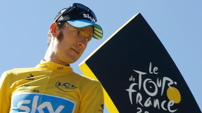 FILE - In this Sunday, July 22, 2012 file photo, Bradley Wiggins, winner of the 2012 Tour de France cycling race, stands on the podium in Paris, France. A British parliamentary committee says in a doping investigation report that Bradley Wiggins used a banned powerful corticosteroid to enhance his performance and not for medical reasons while winning the Tour de France in 2012. The report accuses Team Sky of crossing an “ethical line†after preaching zero tolerance. Team Sky criticized “the anonymous and potentially malicious claim†by members of parliament. (AP Photo/Laurent Cipriani, File)