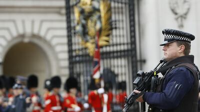 An armed police officer keeps guard outside Buckingham Palace in London, UK, where the authorities are swamped with terrorism-related cases. Kirsty Wigglesworth / AP Photo