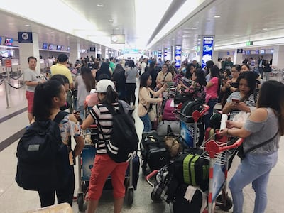 Filipino nationals prepare to fly out of Dubai to Manila in August as part of the UAE's amnesty programme. Reem Mohammed / The National
