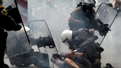 Riot police arrest a protester during clashes in central Athens in 2011. Petros Giannakouris / AP