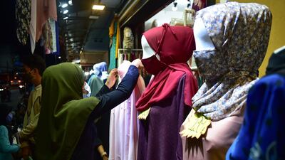Members of the Muslim community wearing face masks amid concern over the spread of the Covid-19 shop for clothes at a market in the southern Thai province of Narathiwat, ahead of Eid Al Fitr marking the end of Ramadan. AFP