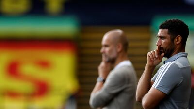 Watford's interim manager Hayden Mullins, right, and Manchester City's Pep Guardiola. AP