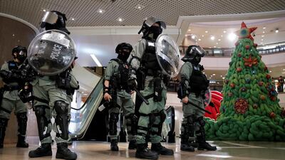 Riot police stand guard next to a Christmas tree inside a shopping mall during an anti-government protest on Christmas Eve at Tsim Sha Tsui in Hong Kong, China, December 24, 2019. REUTERS/Tyrone Siu