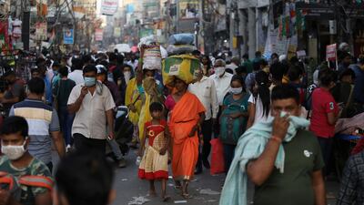 People are seen at a market amid the spread of the coronavirus, in the old quarters of Delhi. Reuters