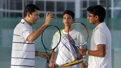 Tennis couch Zeeshan Ali (L) during a class with Sandip Roy and Adarsh Ramesh at the Dubai Modern High School tennis court. Jaime Puebla / The National