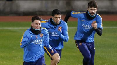 Barcelona’s Lionel Messi, Luis Suare and Gerard Pique run on Monday during the team’s training session in Japan. Toru Hanai / Reuters