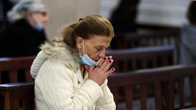 A worshipper wearing a protective mask amid the Covid-19 pandemic attends Christmas morning mass at the Maronite Church of Saint Anthony of Padova in Lebanon's capital Beirut. AFP