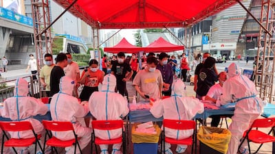People receive nucleic acid tests for the Covid-19 in Shenzhen, in China's southern Guangdong province. AFP