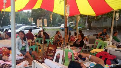 Patients and residents rest outside a hospital in Makilala town, North Cotabato province in southern island of Mindanao on October 17, 2019, after a 6.3 magnitude earthquake hit the island. A child was killed in a strong 6.4-magnitude quake that hit the southern Philippines on Wednesday, a local mayor said, as houses collapsed, power was knocked out and a shopping mall burst into flames. / AFP / Geonarri SOLMENARO