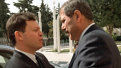 Jordanian Crown Prince Abdallah ibn Hussein (L) talks to Fayez Tarawneh before a Cabinet meeting in Amman in February. AFP