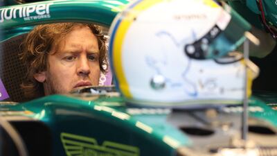 Sebastian Vettel sits in his Aston Martin car at the Melbourne Grand Prix Circuit. Reuters