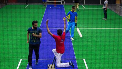 A group of men play indoor cricket at the Insportz Club in the Al Quoz area of Dubai. Christopher Pike / The National