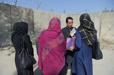 Afghan MP Ramazan Bashardost speaks with women in Kabul. He says that Iran is using Afghan men to fight in Syria and "treats them like slaves". Shah Marai / AFP