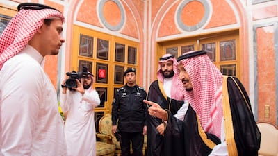 King Salman speaks to Salah, son of Jamal Khashoggi, as Crown Prince Mohammed bin Salman looks on in Riyadh on October 23, 2018. Saudi Press Agency via AP