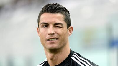 Real Madrid's Cristiano Ronaldo winks during a training session ahead of Tuesday's Champions League semifinal first leg soccer match between Juventus and Real Madrid, at Turin's Juventus Stadium, Italy, Monday, May 4, 2015. (AP Photo/Massimo Pinca)