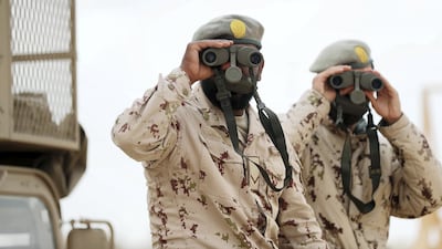 Emirati troops observe the landscape. Chris Whiteoak / The National