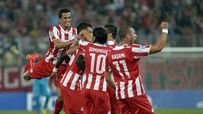 Olympiakos celebrate after scoring during their Champions League win over Atletico Madrid on Tuesday. Louisa Gouliamaki / AFP / September 16, 2014