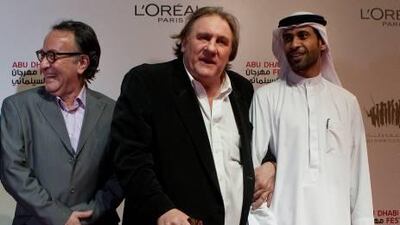 Gerard Depardieu with Peter Scarlett, left, the director of the Abu Dhabi Film Festival, and Eisa Said Rashid Al Mazroui, the project director, at the screening of Potiche in Abu Dhabi yesterday.