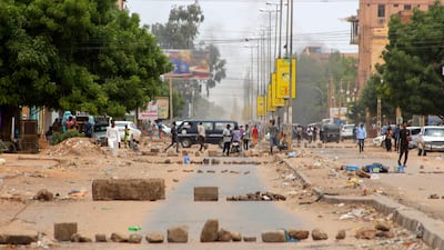 Sudanese protesters take part in an anti-coup rally on a barricaded street in the Daym-Bashdar station area in Khartoum, on July 17. AFP