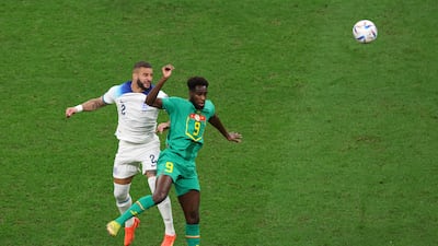 Kyle Walker of England jumps for the ball with Boulaye Dia of Senegal. Getty