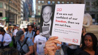 A supporter holds up a placard at a rally in New York in solidarity with Sir Salman Rushdie. AFP