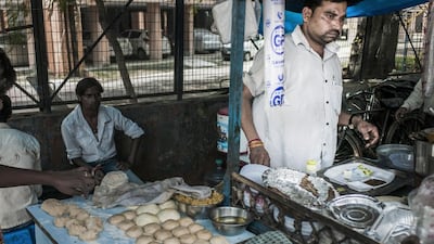 Rajeev Kumar, 40, runs his food stall in New Delhi. Sami Siva for The National