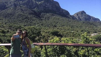 Tourists take picture while taking in the view on the “Boomslang” elevated walk in Kirstenbosch Botanical Gardens near Cape Town. Antonie Robertson