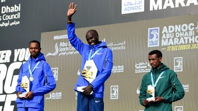 From left, second place runner Felix Kimutai, race winner Timothy Kiplagat, and Adeladhew Mamo at the Abu Dhabi Marathon.