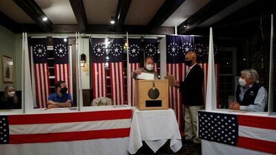 People vote shortly after midnight for the US presidential election at the Hale House at Balsams Hotel in the hamlet of Dixville Notch. Reuters