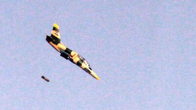 A Syrian Aero L-39 Albatros war plane dropping a payload above buildings across the border in Syria during air strikes backing a Syrian-government-led offensive. AFP