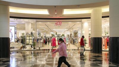 Shoppers wearing protective face mask to prevent the spread of the coronavirus at Mall of the Emirates in Dubai. Authorities ease the restriction for the residents in Dubai. At present mall opening timing is 12:00 pm to 10:00 pm. Pawan Singh / The National