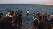Young Palestinian men jump into the sea from the port in Khan Yunis, southern Gaza Strip. EPA