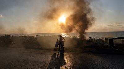 Displaced Palestinians from the northern Gaza Strip flee with their belongings along Al Rasheed Street, west of Gaza city. EPA