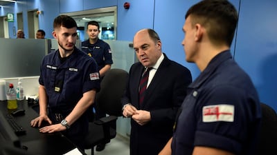UK Defence Secretary Ben Wallace, centre, at Manchester airport in December meeting members of the military covering for striking Border Force officers. AP