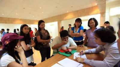 Parents line-up for applications for their children at the former August the 6th school.