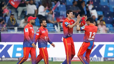 Dubai Capitals' Farhan Khan, second right, celebrates the wicket of Kusal Perera of MI Emirates during their DP World ILT20 match in Dubai. Photo: CREIMAS / ILT20